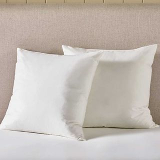 set of two square pillows on a bed