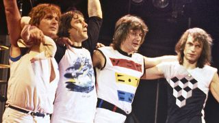 (MANDATORY CREDIT Ebet Roberts/Getty Images) British rock group Asia wave goodbye after performing at the Palladium in New York City on May 2, 1982. (L-R) John Wetton, Carl Palmer, Geoff Downes, Steve Howe (Photo by Ebet Roberts/Redferns)