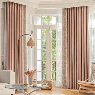 A light-filled living room with light pink curtains