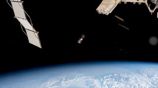 Three small cubesats, including the wooden LignoSat, deploy from the International Space Station. NASA posted this photo via X on Dec. 13, 2024.