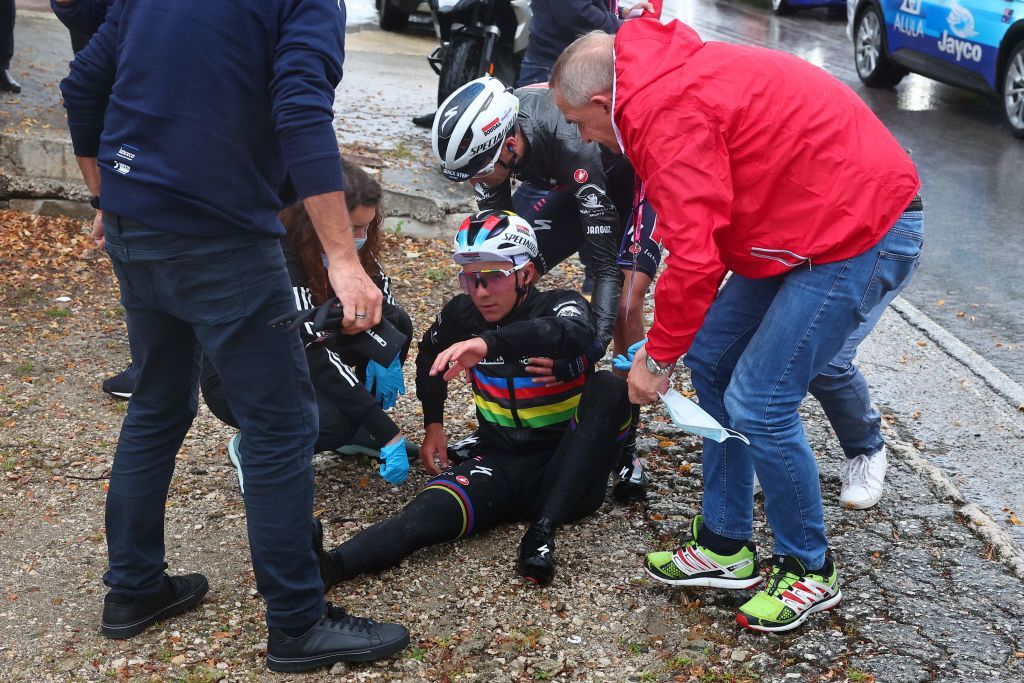 Soudal Quick Steps Belgian rider Remco Evenepoel is assisted by members of his team after crashing during the fifth stage of the Giro dItalia 2023 cycling race 171 km between Atripalda and Salerno on May 10 2023 Photo by Luca Bettini AFP Photo by LUCA BETTINIAFP via Getty Images