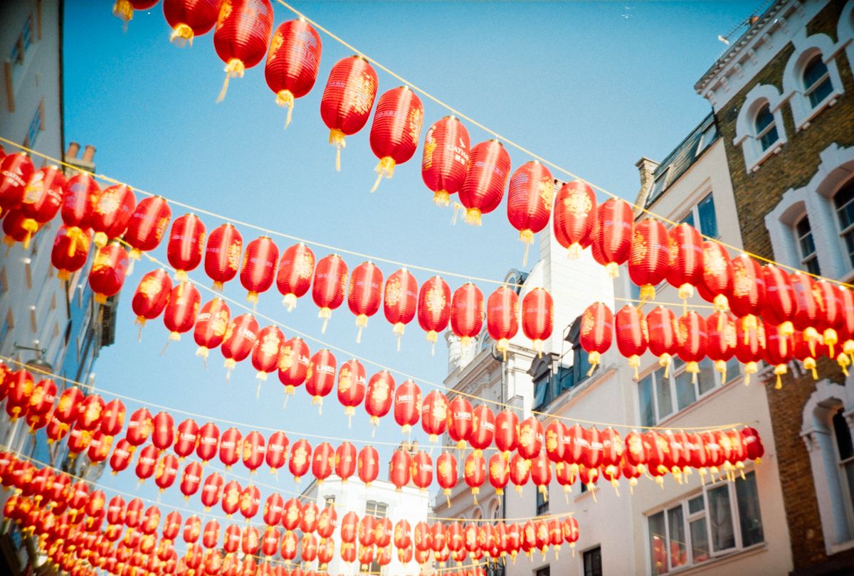 Scanned and digitized film image, using Valoi Easy 35 Pro V2 and Negative Lab Pro Lightroom plugin. Image shows Chinese-style lanterns hanging over a street at daytime in London's Chinatown