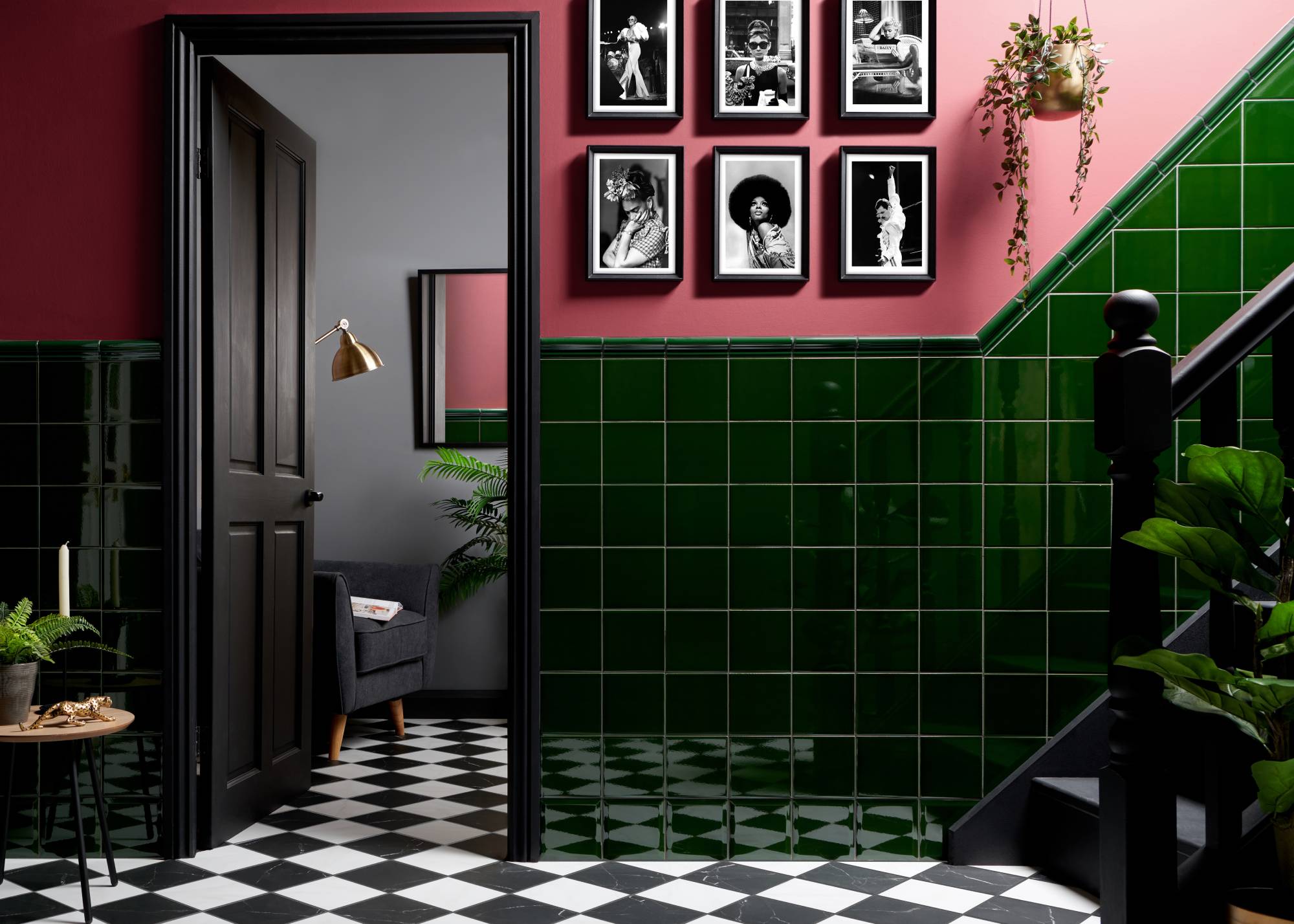 dark green wall tiles on staircase with pink walls and checkerboard floor
