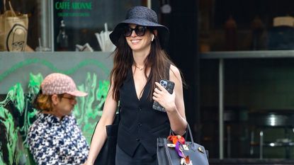 Anne Hathaway wearing an all-black outfit while out running errands in New York City June 2024