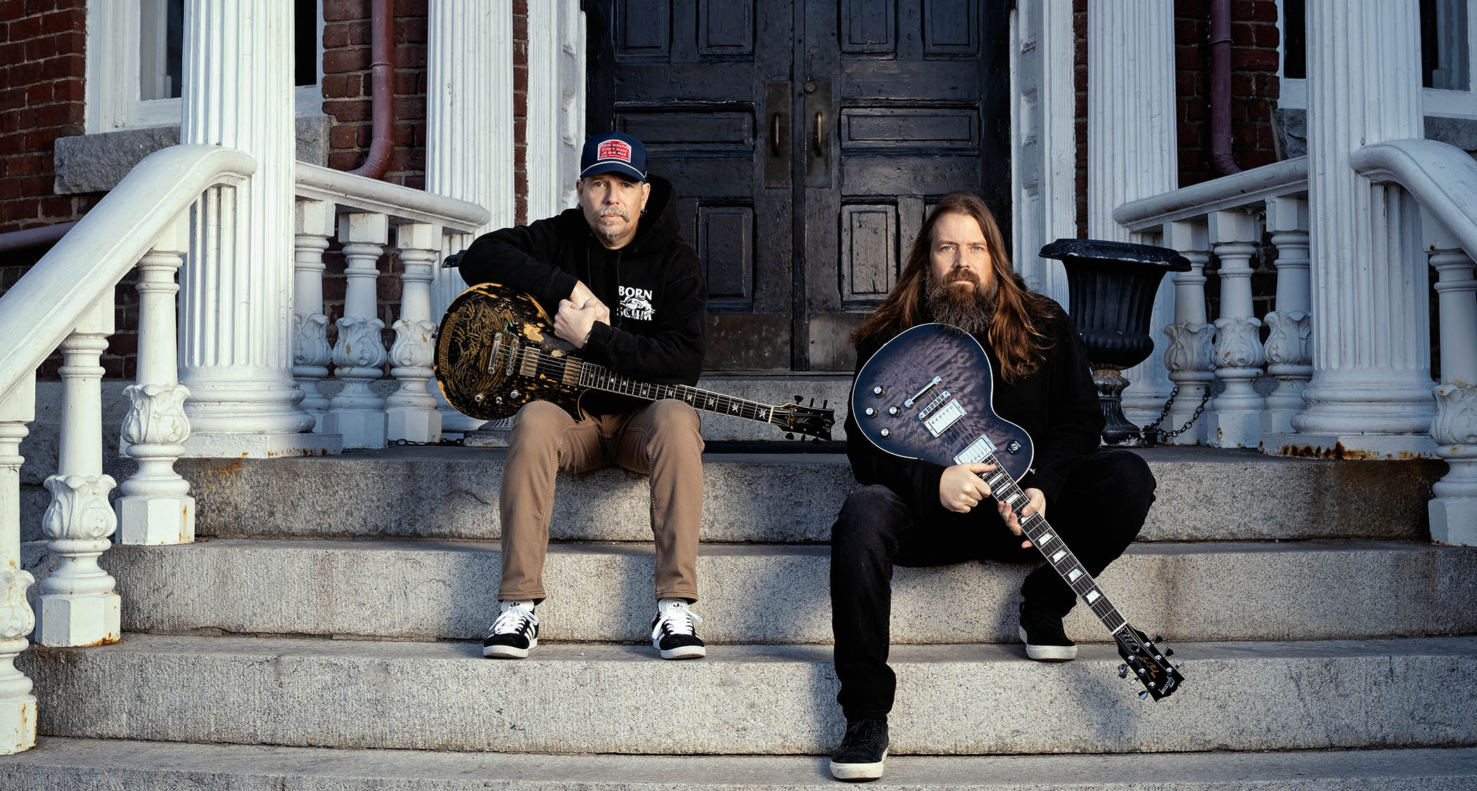 Willie Adler and Mark Morton of Lamb of God are photographed with their signature ESP and Gibson guitars respectively.