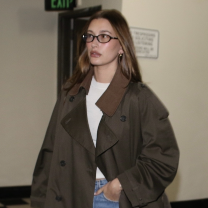 hailey bieber wears a brown trench coat and jeans while out to dinner with kendall jenner at sushi park on jan. 7