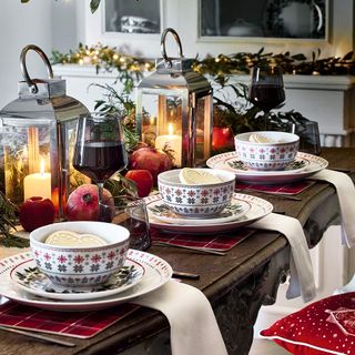 Dining table with lanterns and Christmas flatware