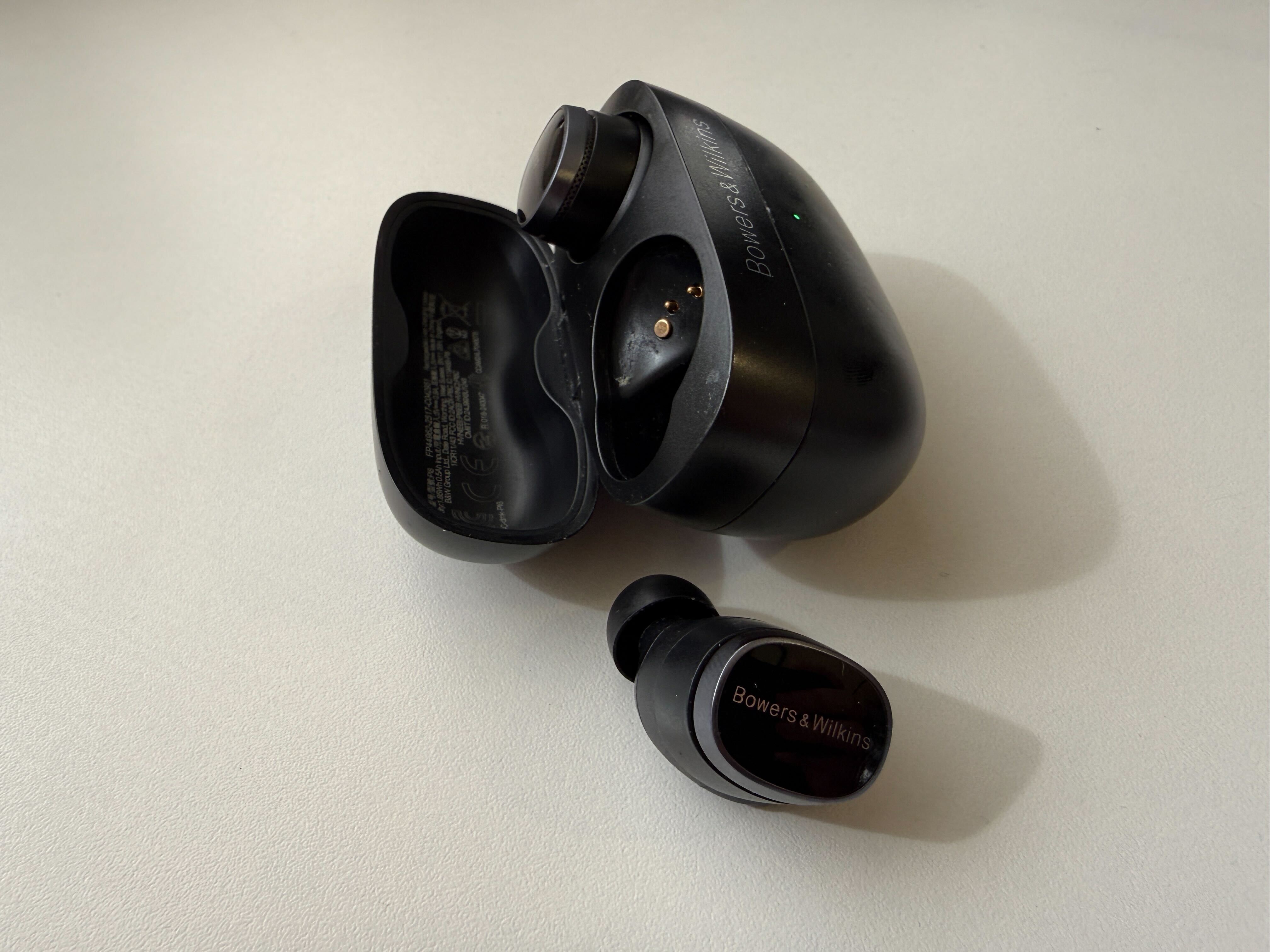 A pair of wired earbuds on a white table