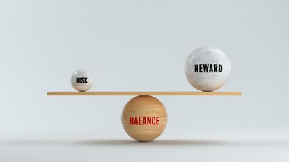 Balls with the words "risk" and "reward" sit on opposite ends of a seesaw sitting on top of a ball that says "balance."