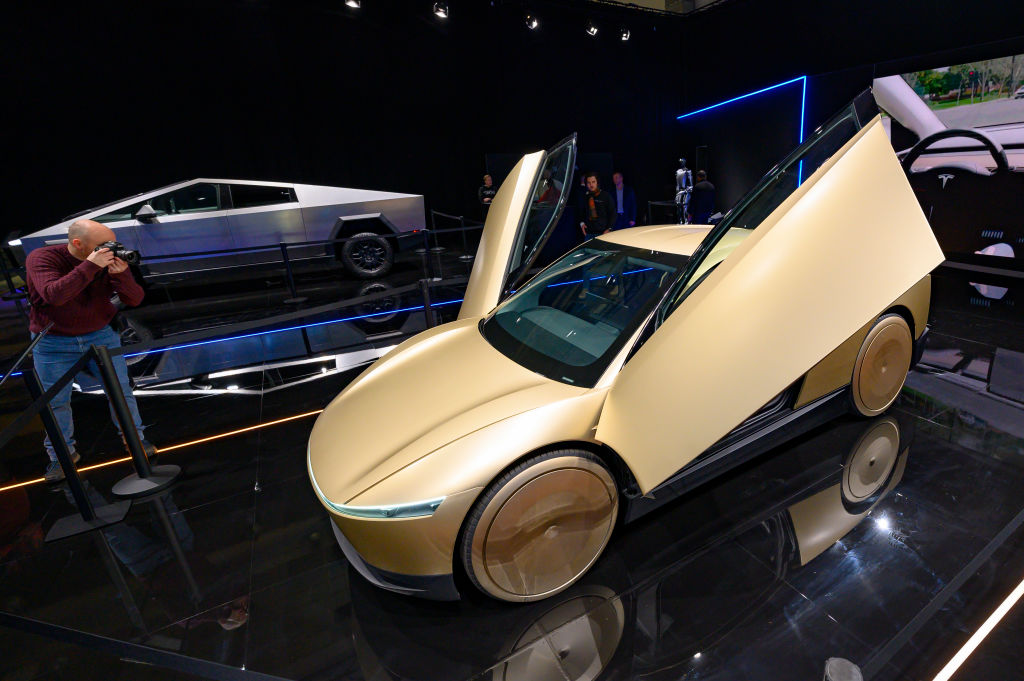 Tesla Cybercab or Robotaxi two-passenger battery-electric self-driving car and Tesla Cybertruck battery electric pickup truck on display at the 2025 Autosalon on January 10, 2025 in Brussels, Belgium
