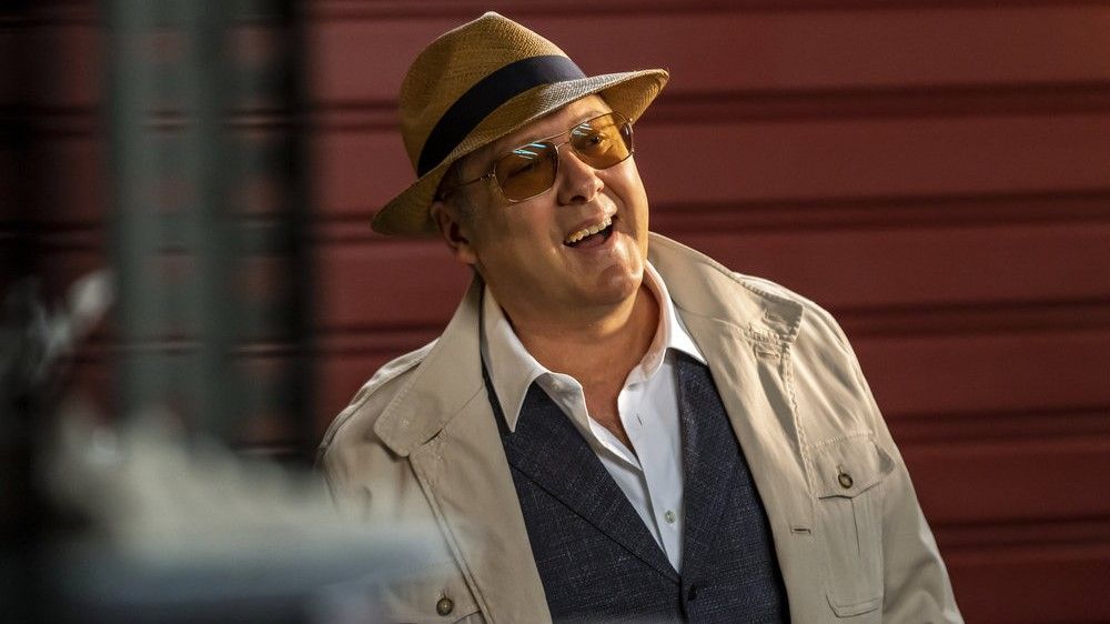 James Spader as Raymond Reddington in a hat smiling in The Blacklist season 10