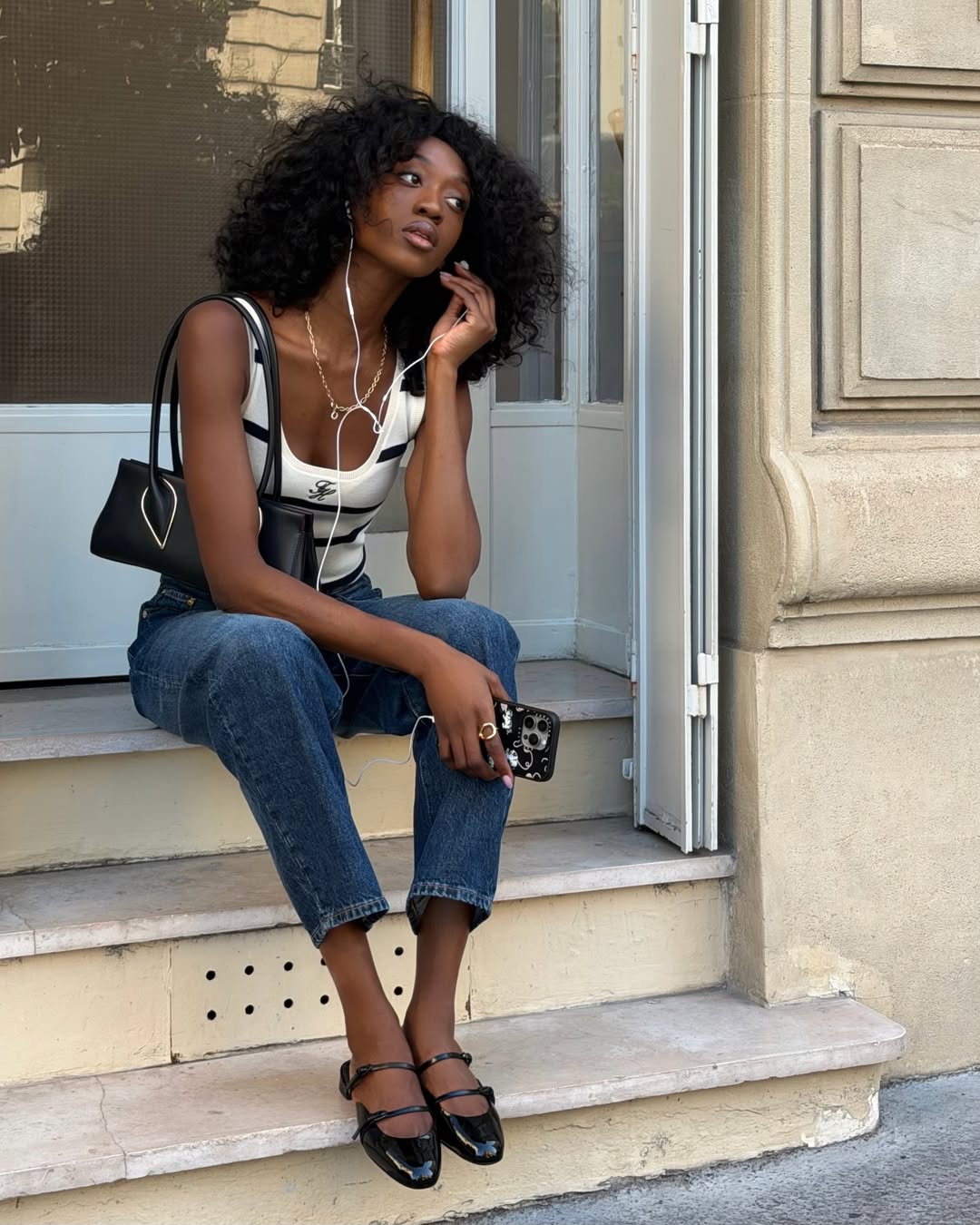 Emmanuelle in striped vest and flat mules