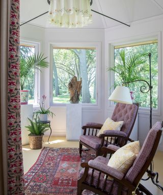 turret room with armchairs and with white walls