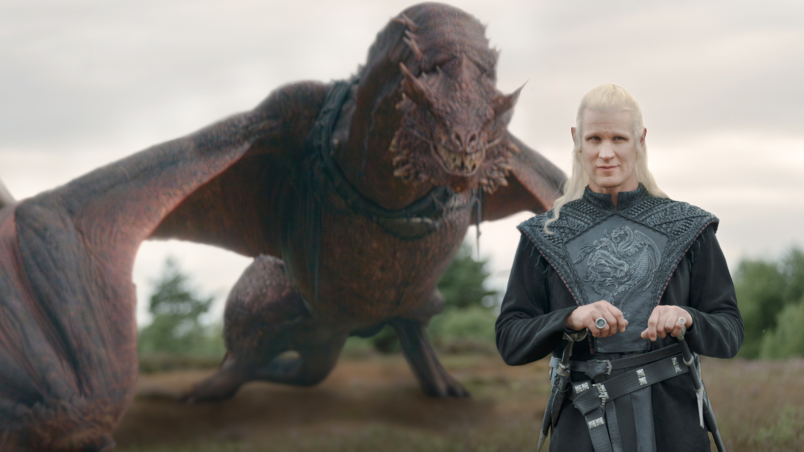 Prince Daemon Targaryen standing in a field with Caraxes behind him in House of the Dragon season 3 episode 3