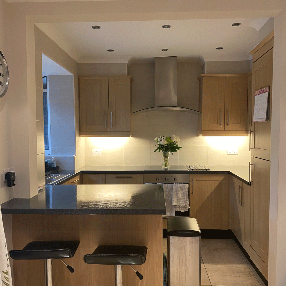 Oak kitchen with black stools