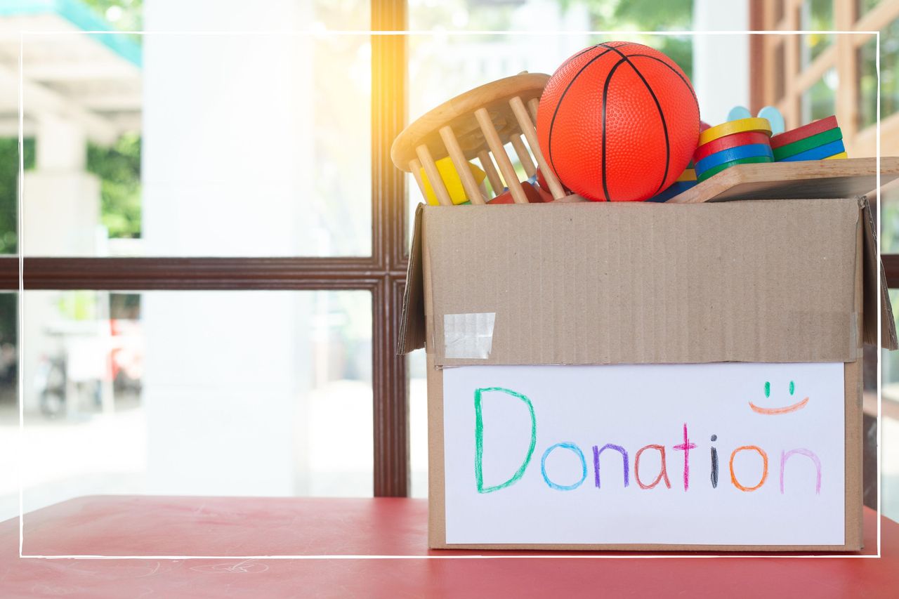 cardboard box, filled with children&#039;s toys, with the word donations written on it