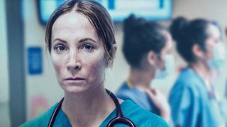 Golden Globe winning actress Joanna Froggatt, dressed in blue medical scrubs, stars in harrowing new pandemic drama Breathtaking 