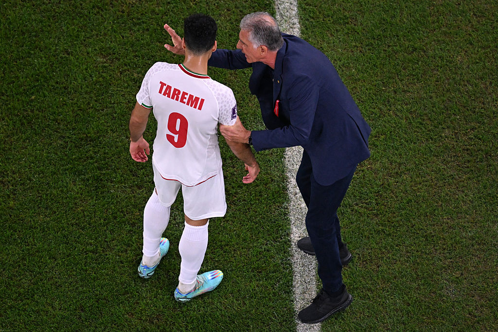 Iran's Portuguese coach #00 Carlos Queiroz speaks with Iran's forward #09 Mehdi Taremi