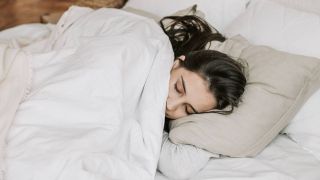 Young woman sleeping under a blanket