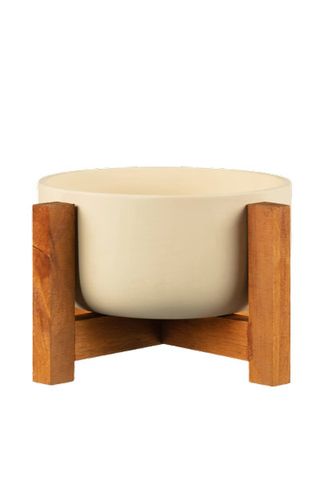 cream planter on a wooden stand