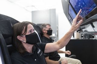NASA astronauts Megan McArthur and Shane Kimbrough can be seen in this image, which McArthur shared to Twitter, at SpaceX, practicing how to fly the company's Crew Dragon vehicle. The pair will make up half of the crew that will fly to the space station with SpaceX's Crew-2 mission, slated for 2021.