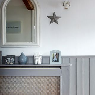 Hallway with grey wall panelling and radiator cover