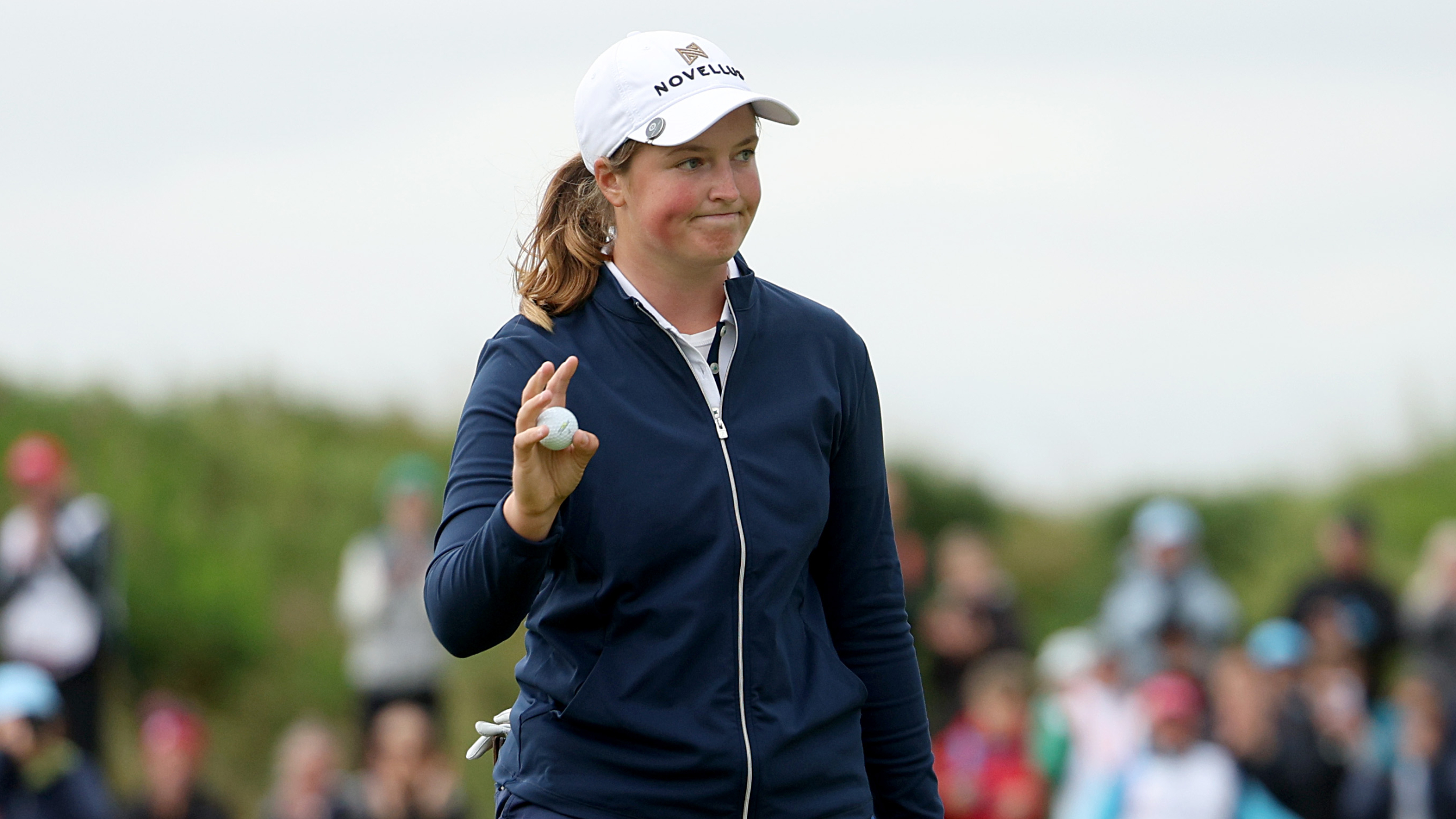 Lottie Woad acknowledges the fans after her win at the ISPS Handa Women's Scottish Open