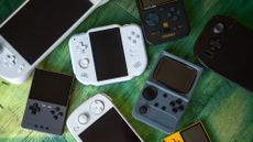Retro gaming handhelds on green wooden floor