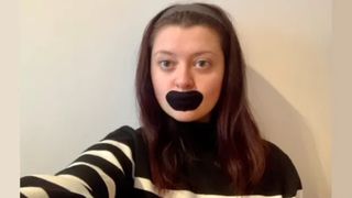 Woman wearing black tape on mouth