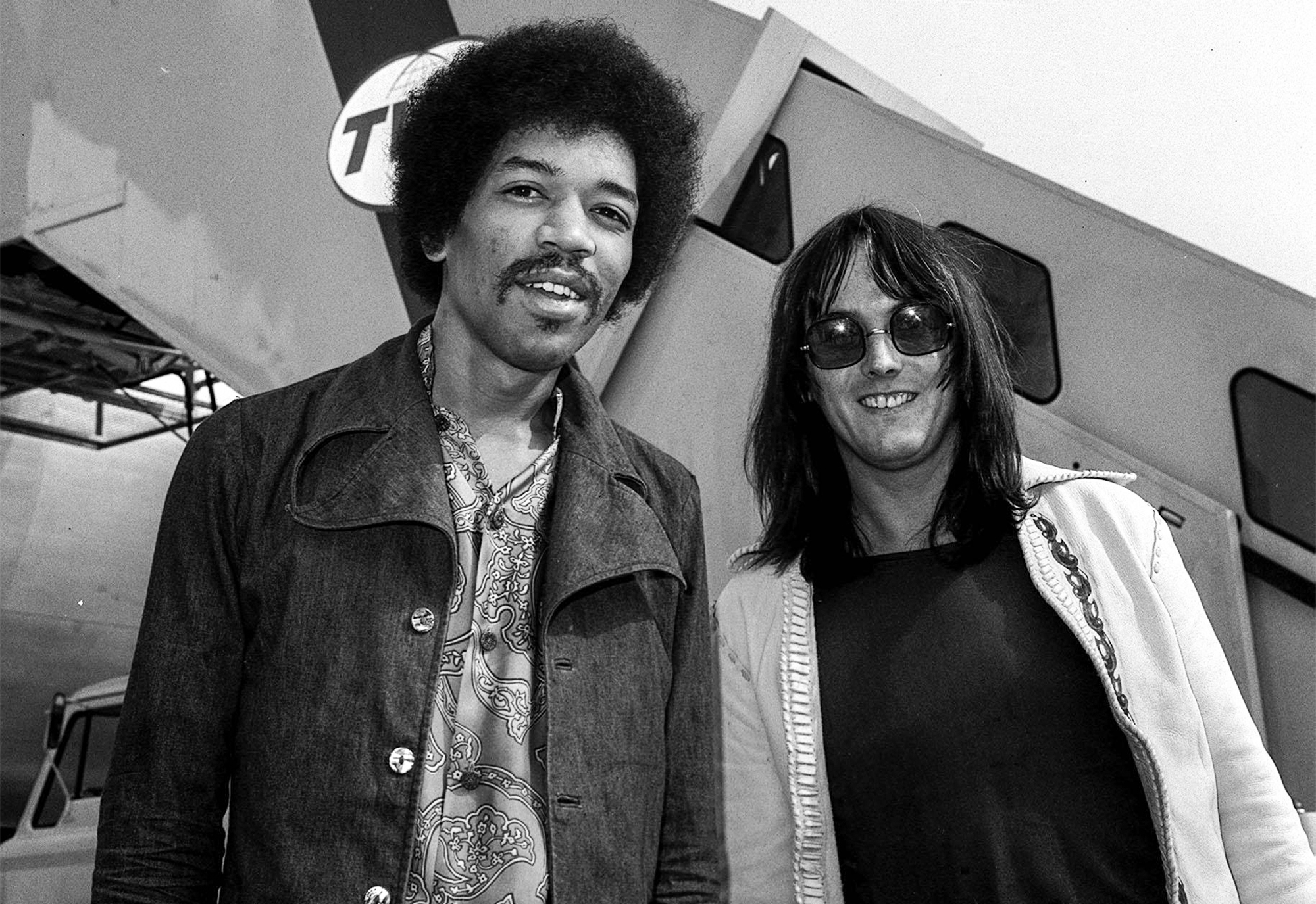 Rock guitarist Jimi Hendrix (left) with his road manager Eric Barrett at Heathrow Airport, after having flown in from New York on his way to the Isle of Wight pop festival, August 26, 1970.
