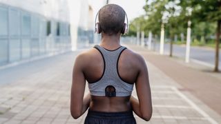 Runner wearing sports bra and headphones