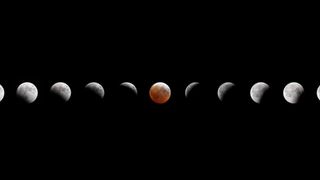 A composite image showing the small gray sphere of the moon across a dark night sky as it reaches various phases of a lunar eclipse. 