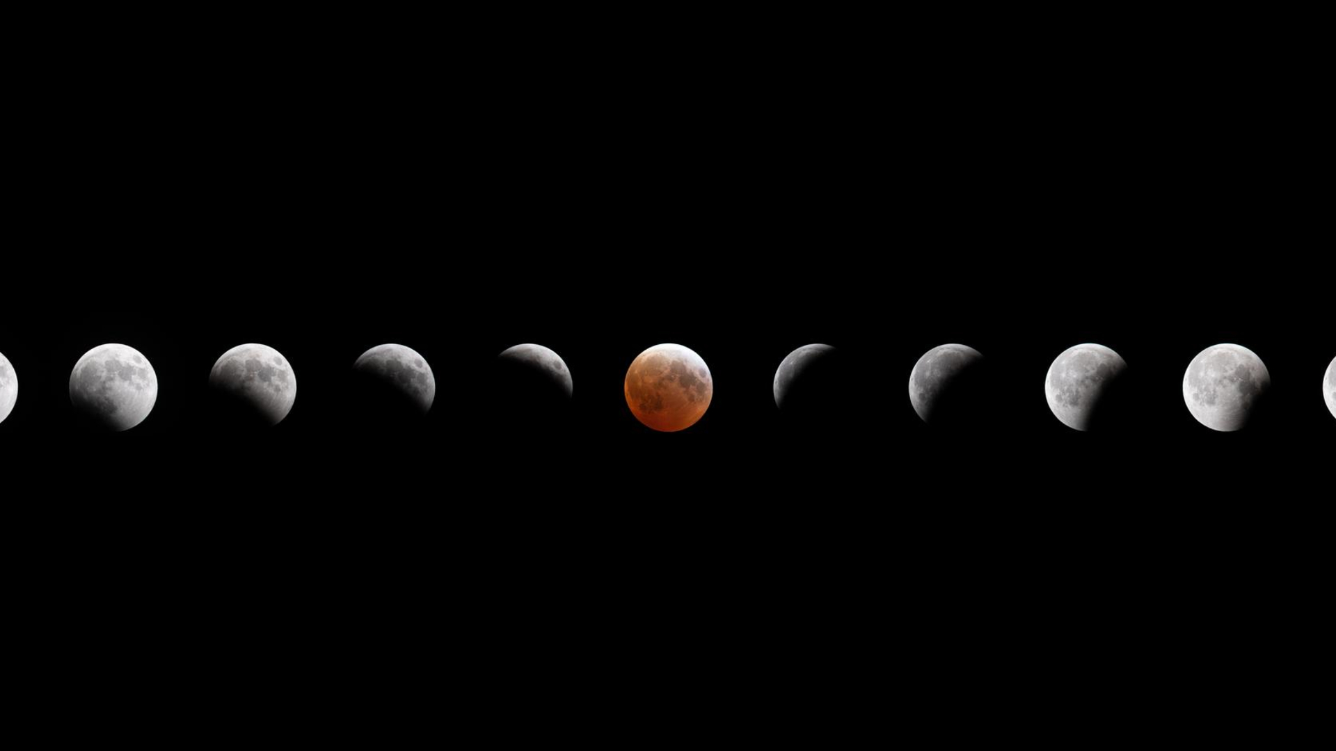 A composite image showing the small gray sphere of the moon across a dark night sky as it reaches various phases of a lunar eclipse. 