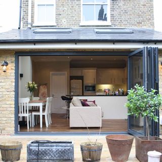 modern flat roof extension with bi-fold doors onto timber deck