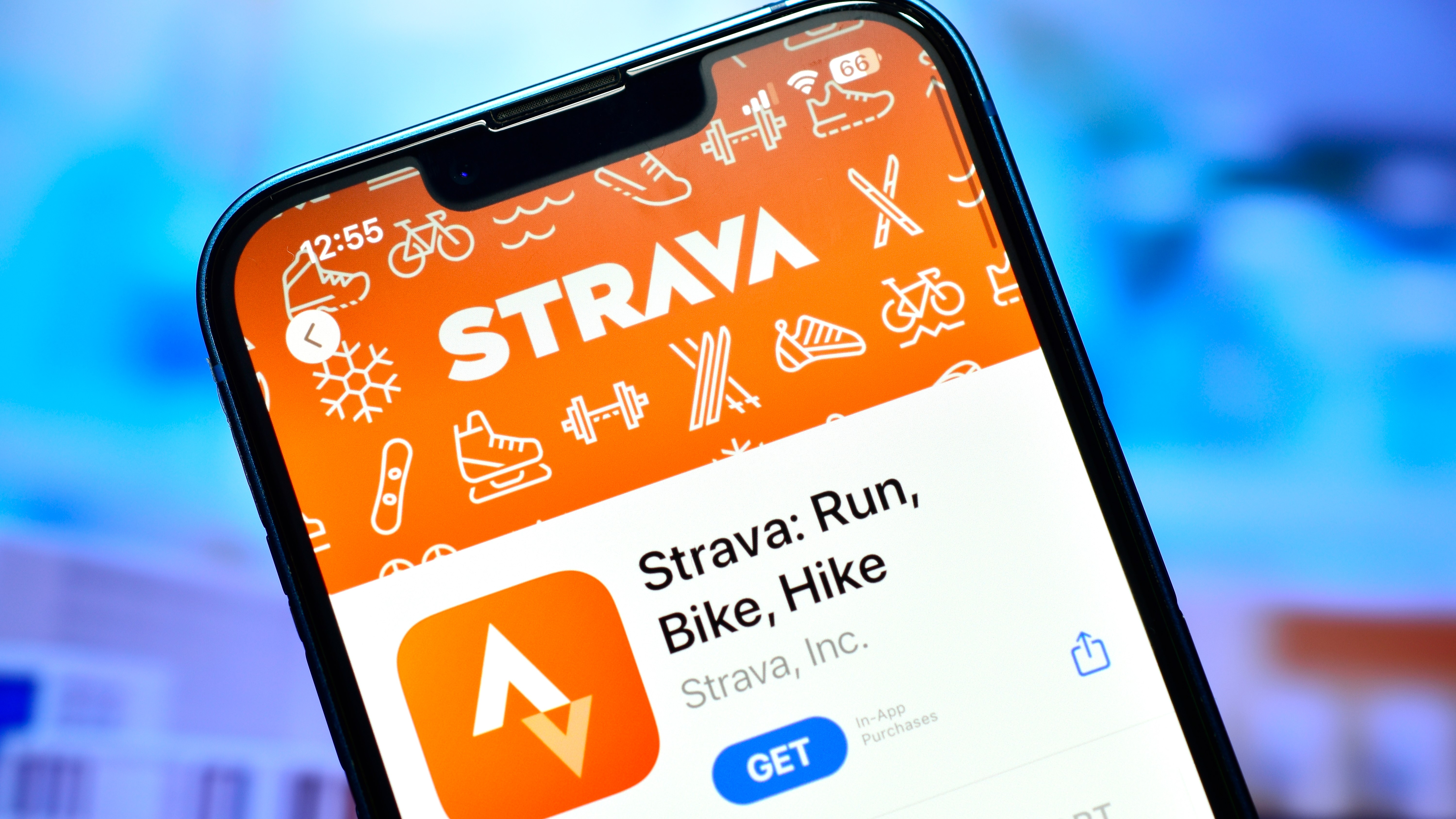 An iPhone with the Strava App Store listing on screen