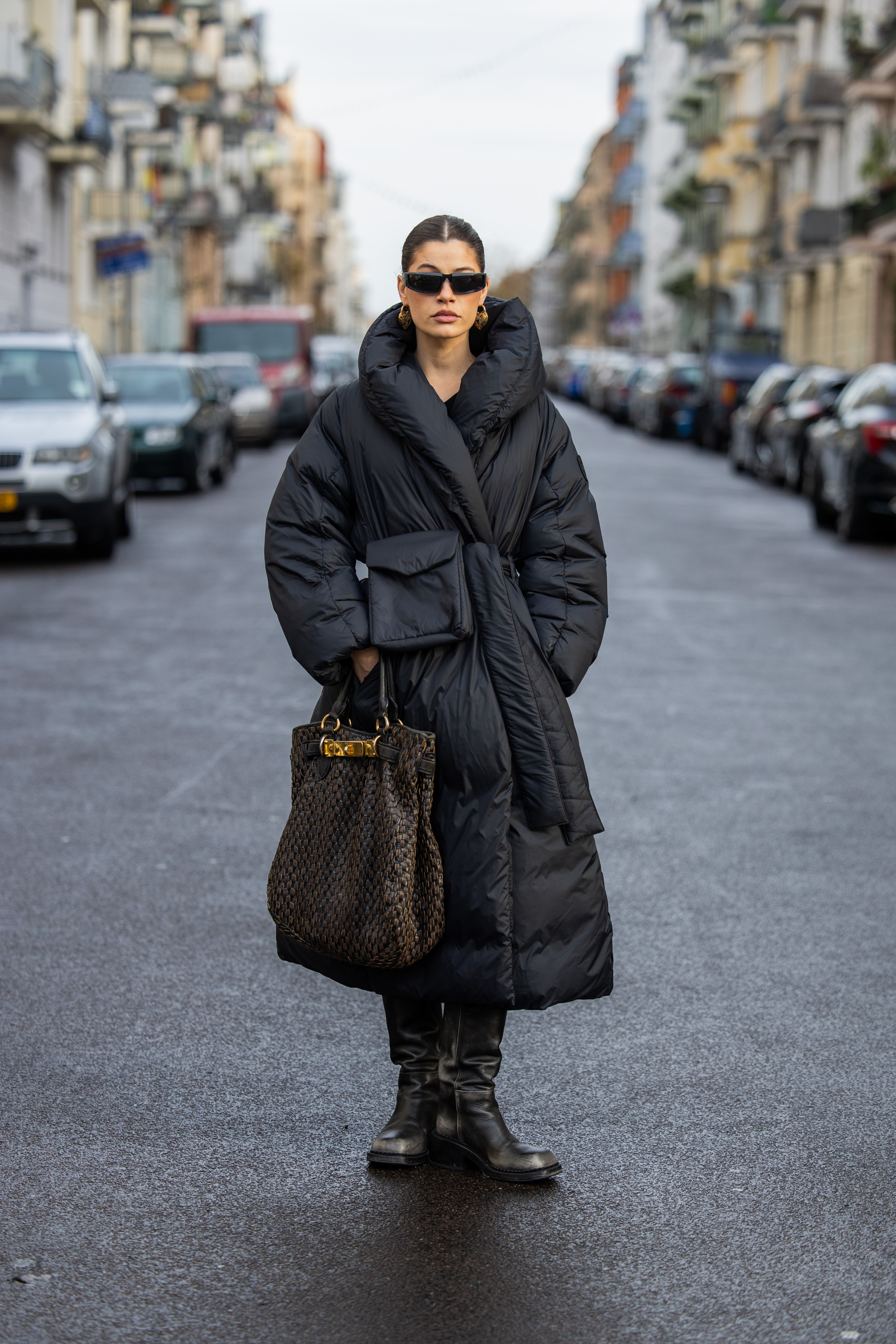 a woman wearing an oversized black puffer jacket