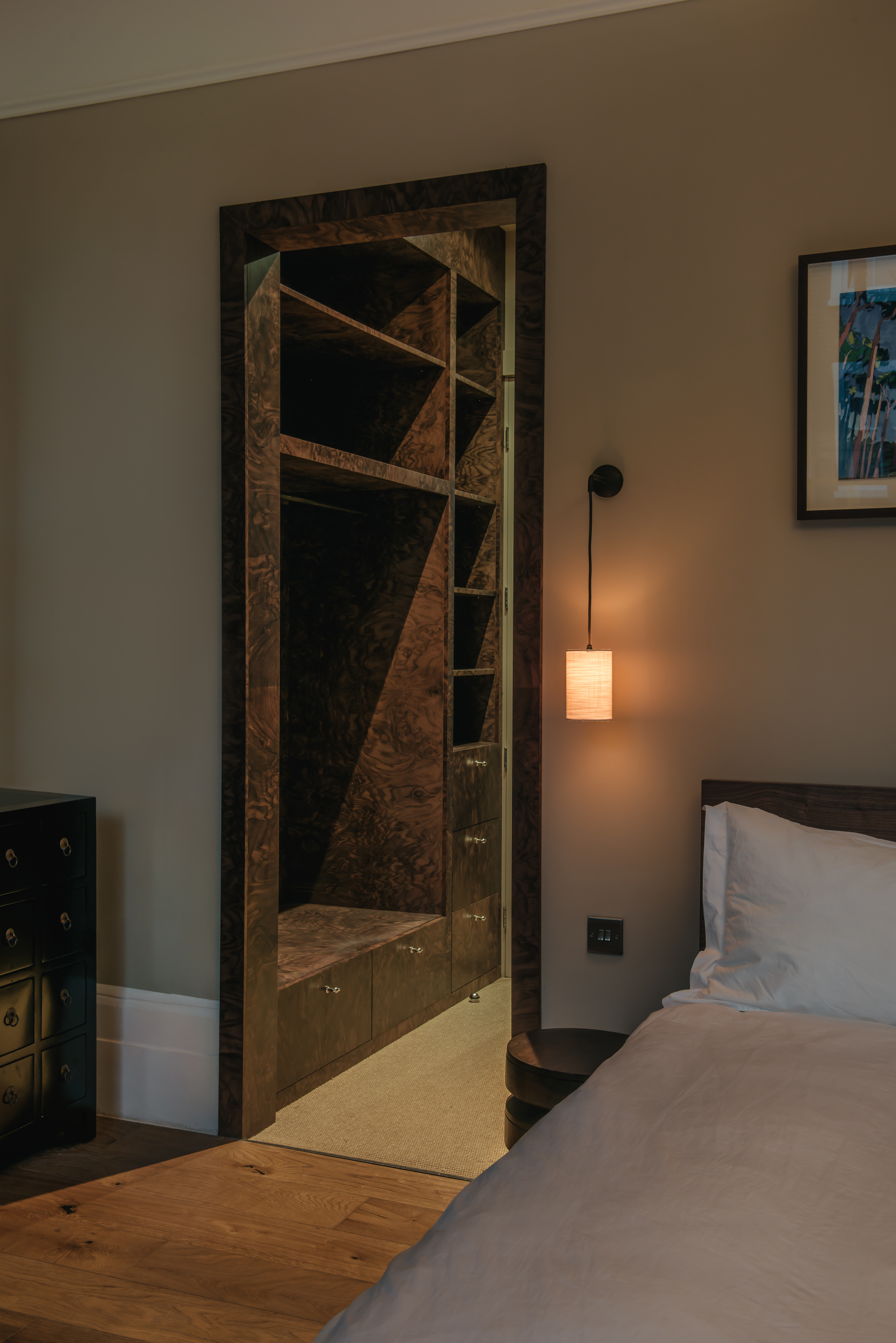 Naturally or beautifully lit rooms distinguished by an earthy palette of cream, green, and wood tones, sleek details, and textural surfaces in fabric, stone, and wood, and softly glowing lighting.