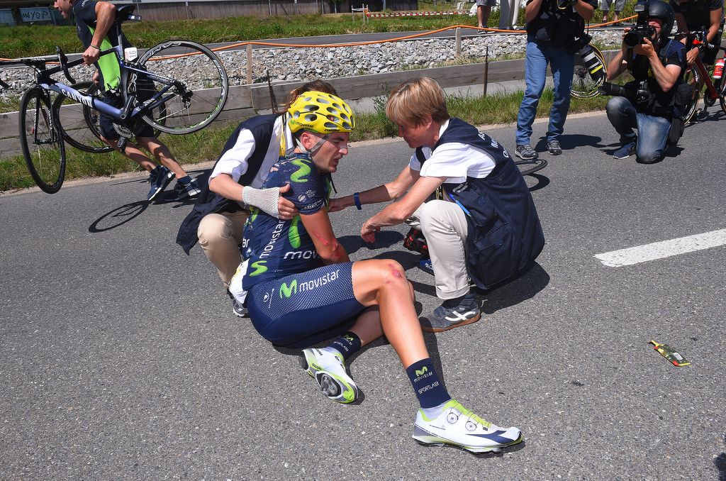 Movistar's Gorka Izagirre is assisted by the medical team after his crash