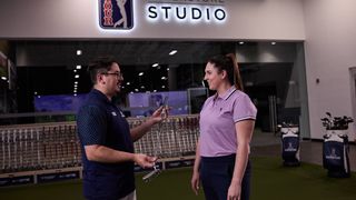 Woman being shown putters