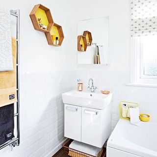 bathroom with white wall and wash basin and honeycomb shape shelves