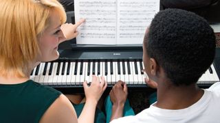 Couple playing Yamaha digital piano