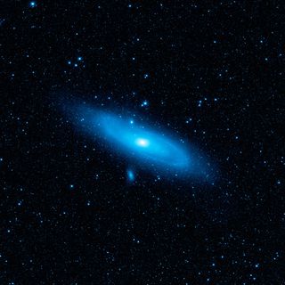 This image from WISE displays the Andromeda galaxy's older stellar population in blue. The disk of the galaxy shows the aftermath of a collision with another galaxy, clear from the warp in the spiral arm at the upper left side.