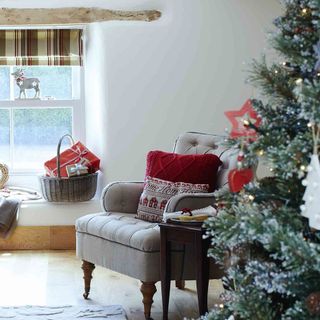 living room with arm chair and christmas tree