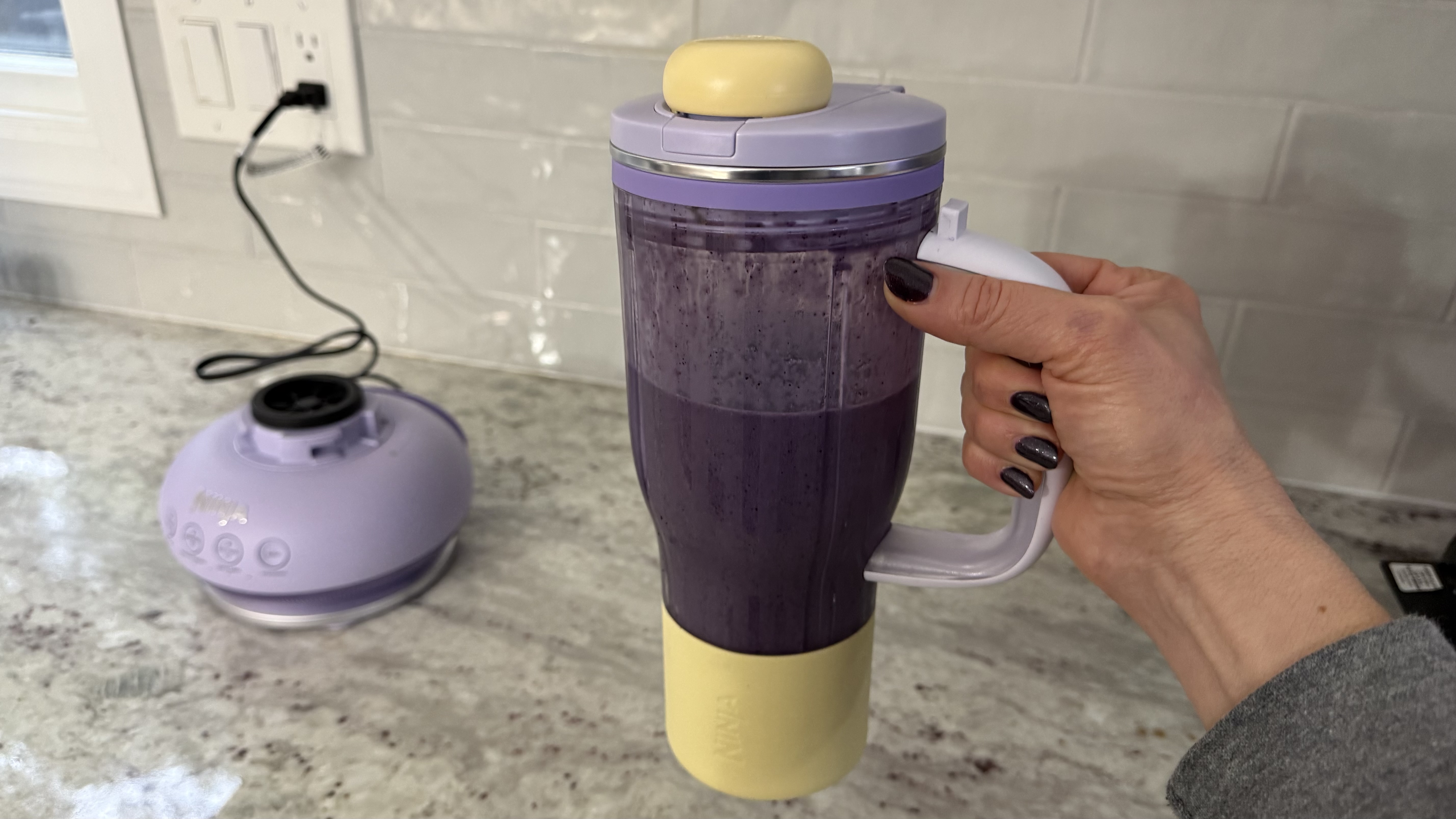 Ninja BlendBOSS&trade; Tumbler Blender with 26oz Travel Tumbler making banana, blueberry, and spinach smoothie