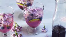 Pretty pink drinks with edible flowers in