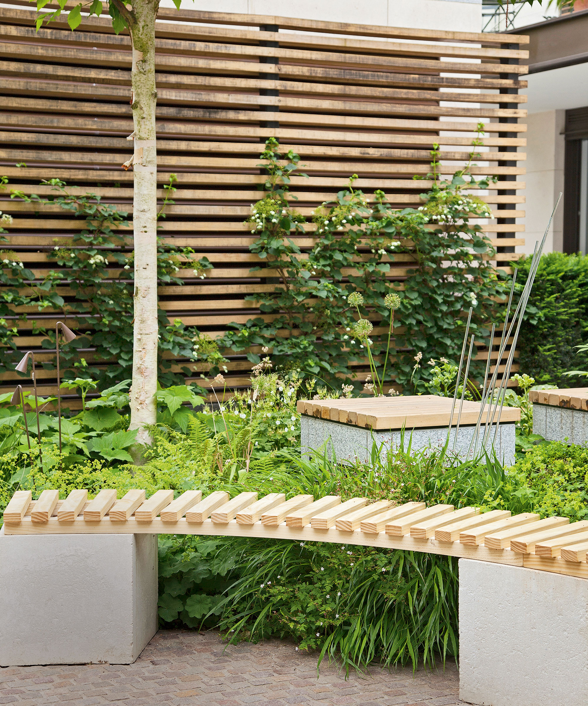 garden area with slated bench and blond wood with coffee table