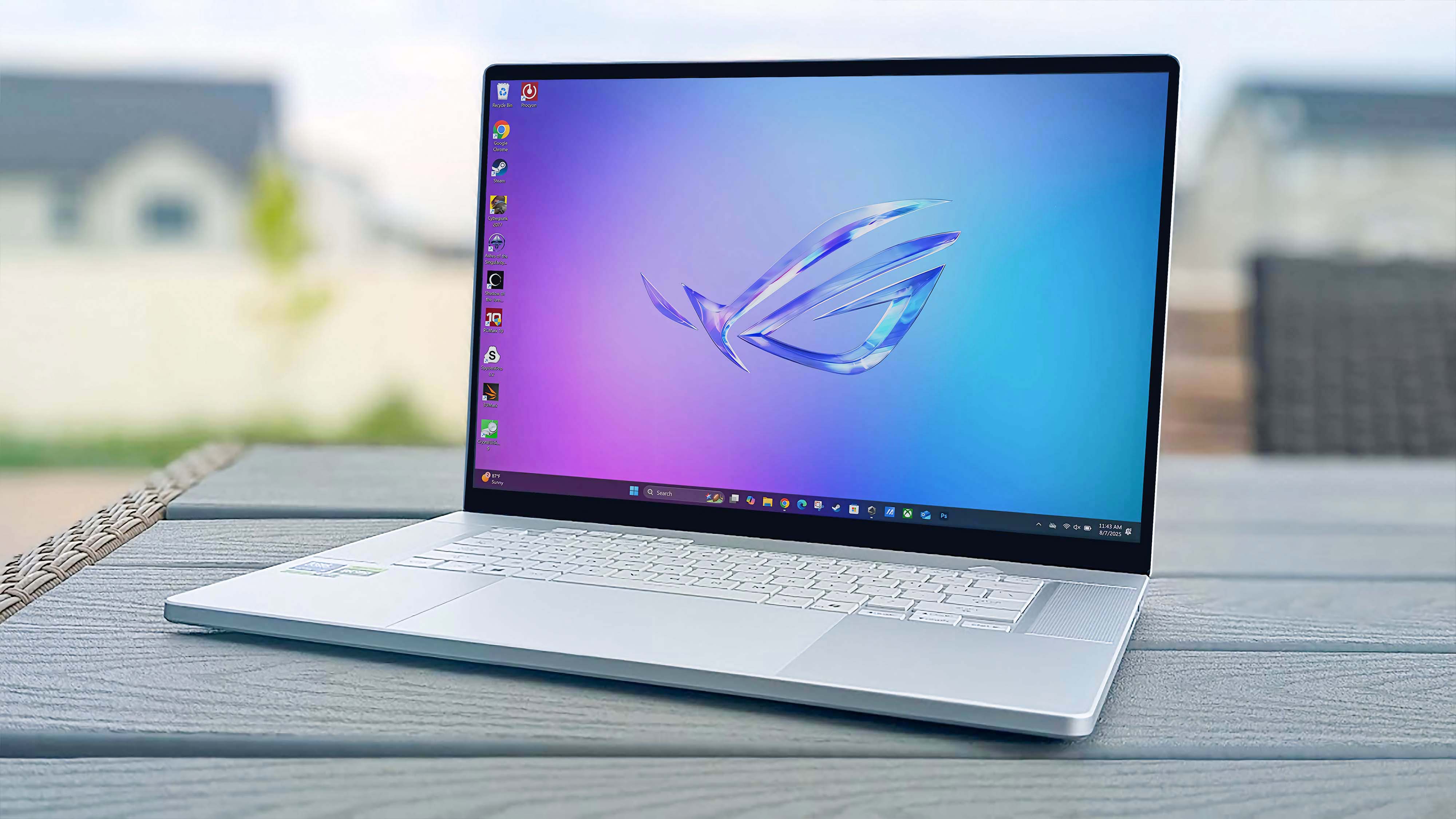 ASUS ROG Zephyrus G16 (GU605C, 2025) on a table outside.