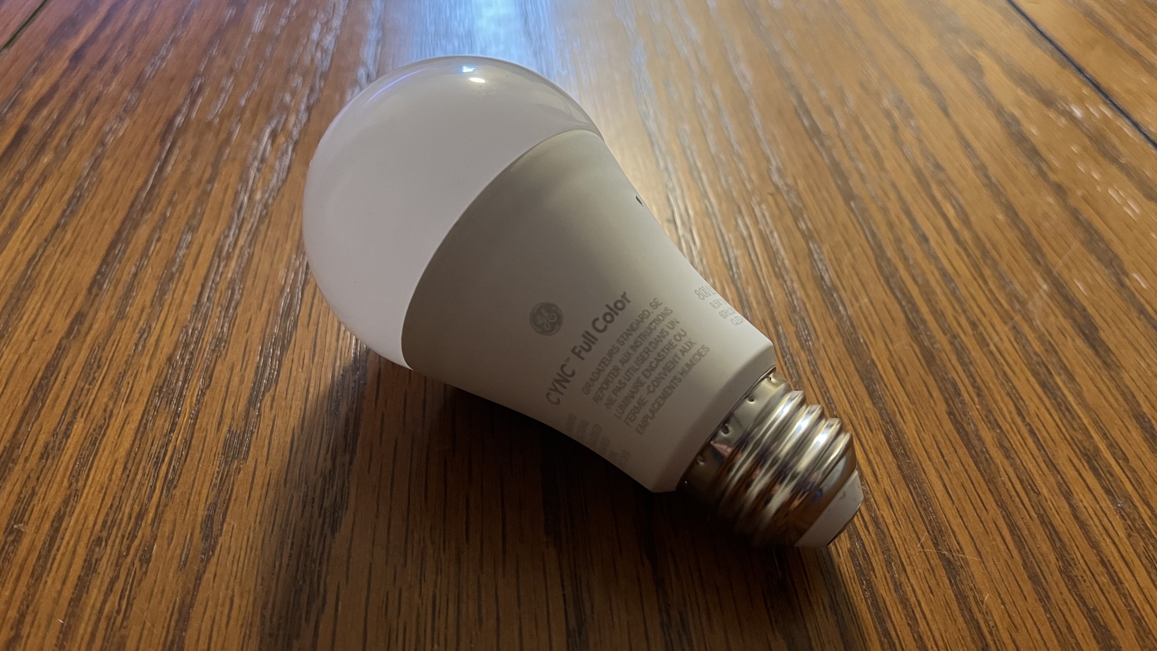 GE Cync Lighting Dynamic Effects Smart Bulb on wooden table