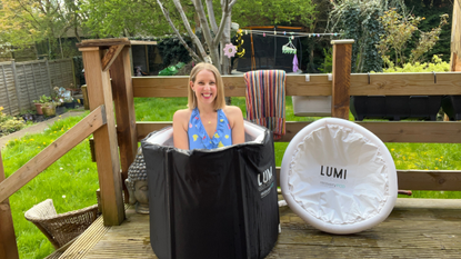 Fitness writer Maddy Biddulph in the LUMI recovery pod inflatable ice bath