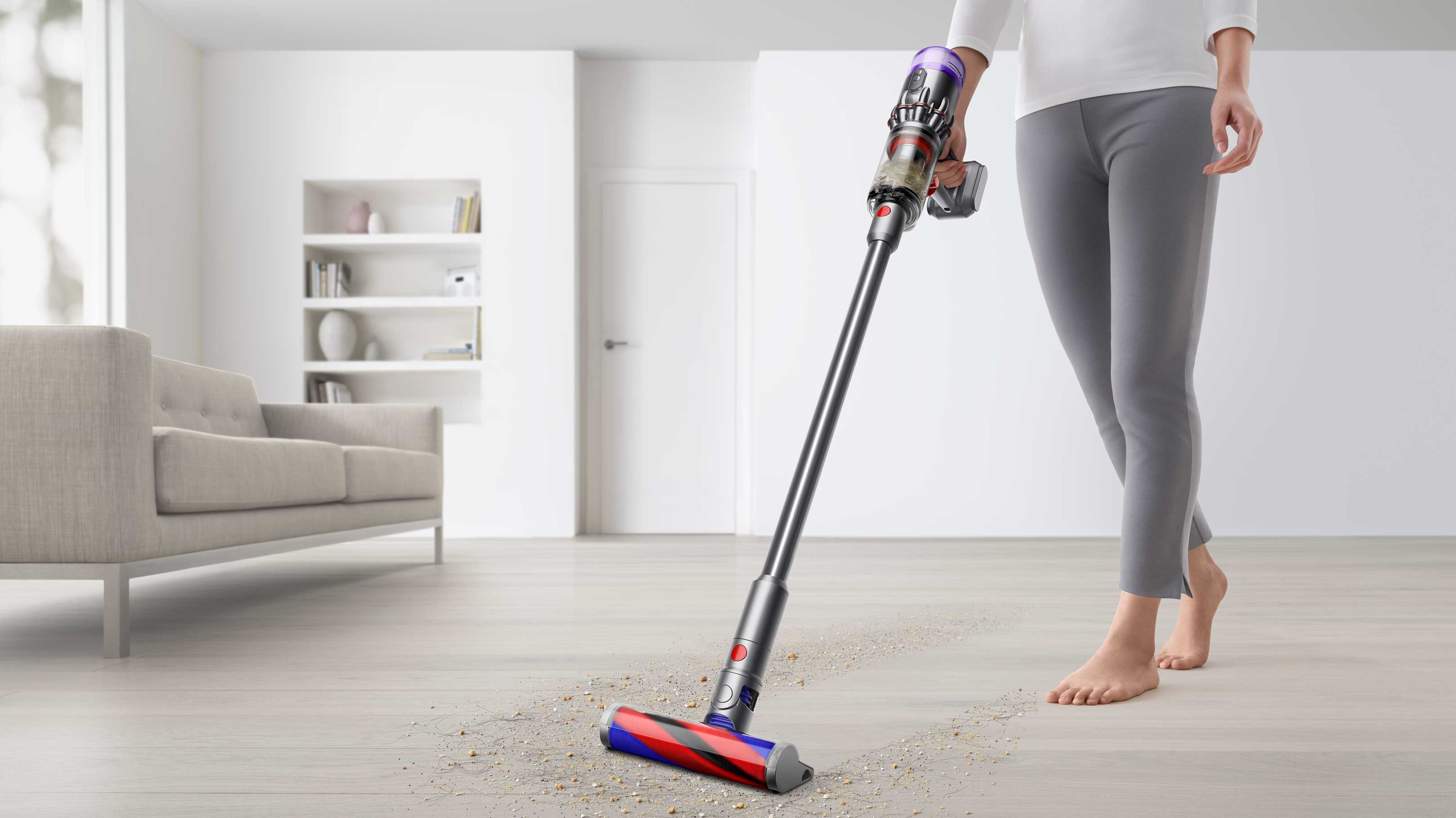 Dyson stick vacuum picking up crumbs